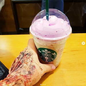 IG post from @evaortega92 of zombie hand holding Starbucks zombie frap