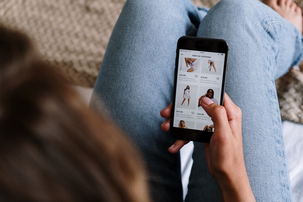 image of someone using shoppable social on a phone - expanded shopping features for Instagram