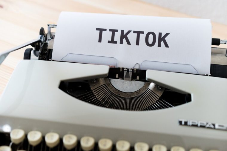 typewriter with the word TikTok bold type at the top of a page