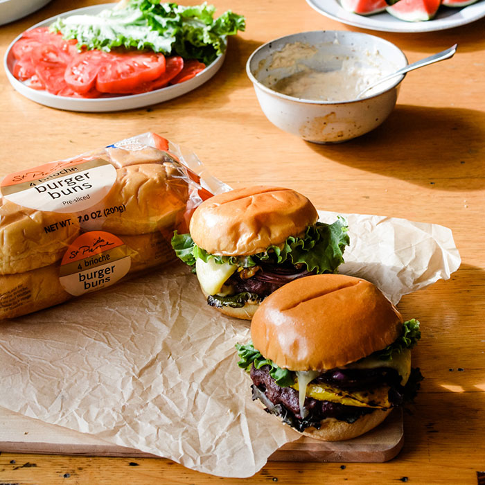 Pic of gourmet burgers on a table  - Kate Ramos for St. Pierre Bakery