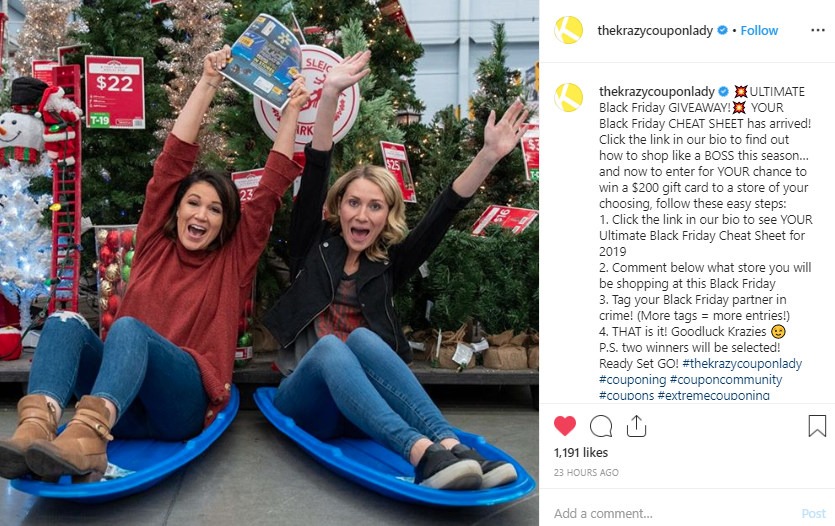 A screenshot of post from @thekrazykouponlady on Instagram of two ladies sitting in front of christmas trees