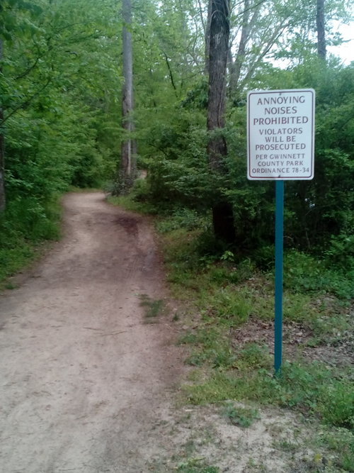 An image from a park with a sign board on Noises.