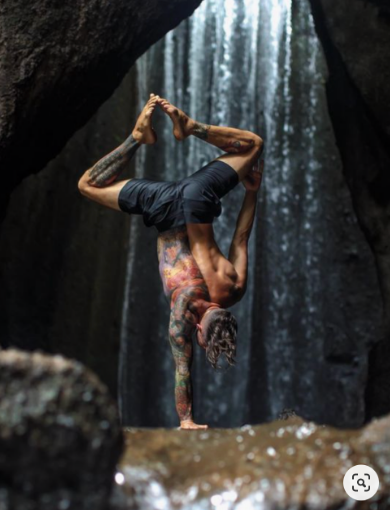 An image of man performing a handstand.