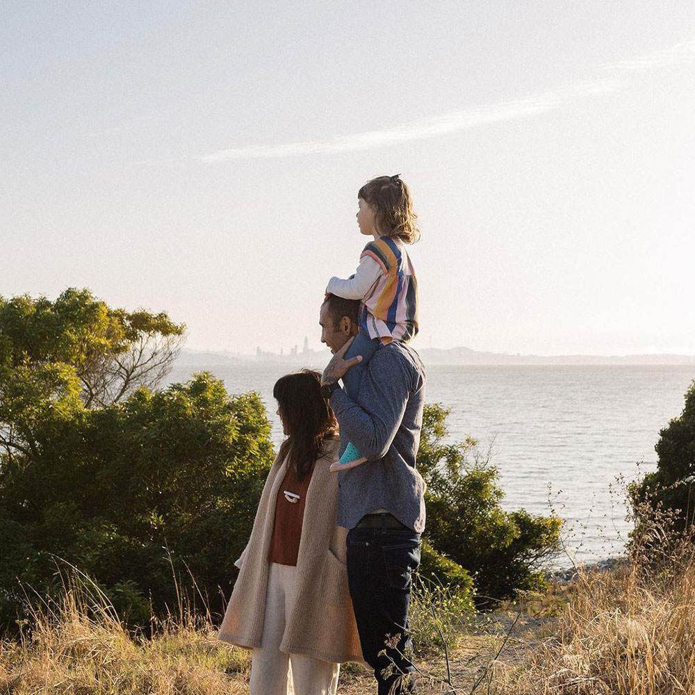 Family of three walking by a beach for Earthjustice influencer campaign