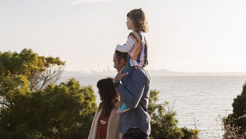 Family of three walking by a beach for Earthjustice influencer campaign