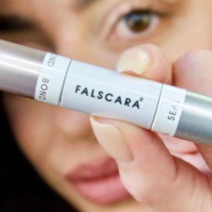 Woman holding up mascara for KISS influencer campaign