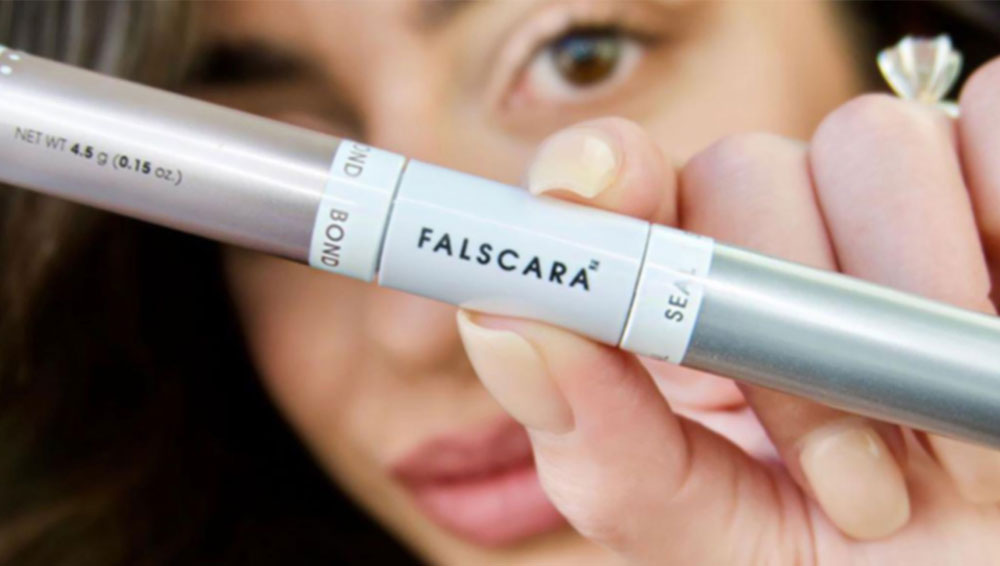 Woman holding up mascara for KISS influencer campaign