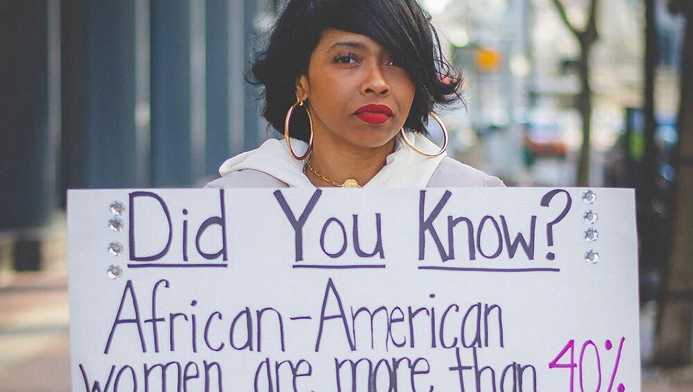 Woman holding up poster for Susan G. Komen influencer campaign