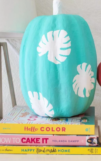 An image of pumkin dressed with cyan coloured paint.