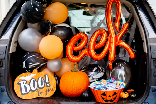 An image of a car's boot filled with halloween goodies.
