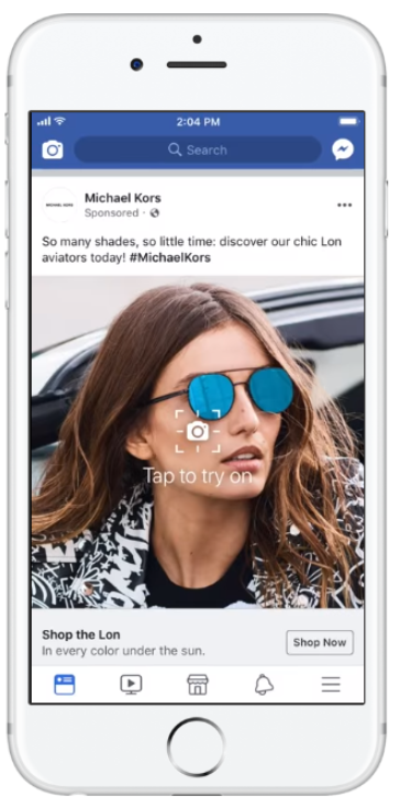 A screenshot of a post from facebook by 'Michael Kors' of a lady wearing blue shades.