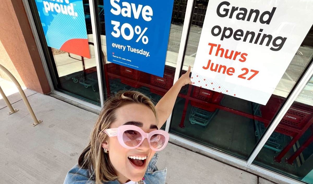 Tezza in front of grand opening sign for Savers Value Village North American store opening push 2024 gtm influencer campaign with The Shelf